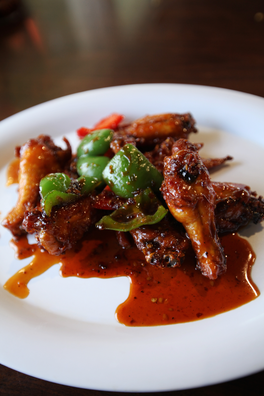 A photo of an order of chicken wings sitting on a plate